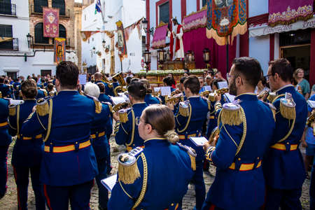 Carmona, Spain - June 19, 2022 Corpus Christi of Carmona, religious procession through the streets to Santa Maria Church, made up of religious statues, young children, christians and a music bandのeditorial素材