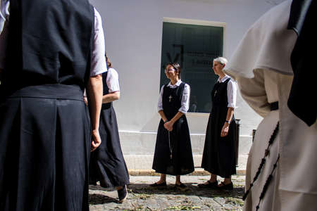 Carmona, Spain - June 19, 2022 Corpus Christi of Carmona, religious procession through the streets to Santa Maria Church, made up of religious statues, young children, christians and a music bandのeditorial素材