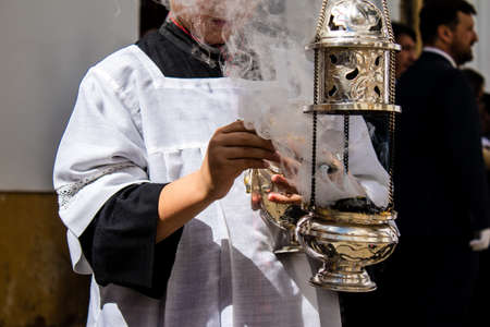 Carmona, Spain - June 19, 2022 Corpus Christi of Carmona, religious procession through the streets to Santa Maria Church, made up of religious statues, young children, christians and a music bandのeditorial素材