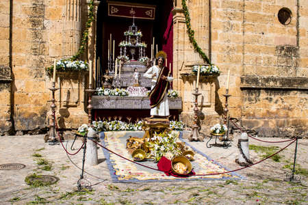 Carmona, Spain - June 19, 2022 Corpus Christi of Carmona, religious procession through the streets to Santa Maria Church, made up of religious statues, young children, christians and a music bandのeditorial素材