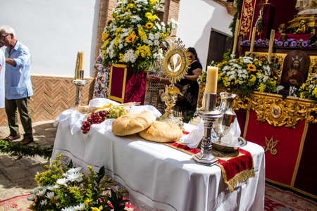 Carmona, Spain - June 19, 2022 Corpus Christi of Carmona, religious procession through the streets to Santa Maria Church, made up of religious statues, young children, christians and a music bandのeditorial素材