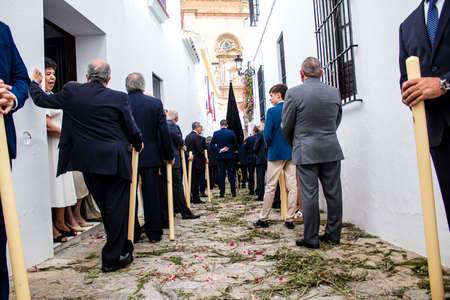 Carmona, Spain - June 19, 2022 Corpus Christi of Carmona, religious procession through the streets to Santa Maria Church, made up of religious statues, young children, christians and a music bandのeditorial素材