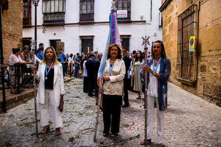 Carmona, Spain - June 19, 2022 Corpus Christi of Carmona, religious procession through the streets to Santa Maria Church, made up of religious statues, young children, christians and a music bandのeditorial素材