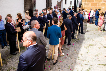 Carmona, Spain - June 19, 2022 Corpus Christi of Carmona, religious procession through the streets to Santa Maria Church, made up of religious statues, young children, christians and a music bandのeditorial素材