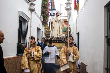 Carmona, Spain - June 19, 2022 Corpus Christi of Carmona, religious procession through the streets to Santa Maria Church, made up of religious statues, young children, christians and a music bandのeditorial素材