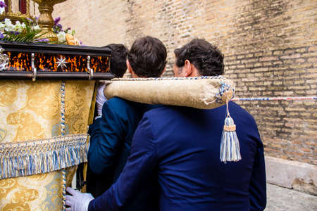 Carmona, Spain - June 19, 2022 Corpus Christi of Carmona, religious procession through the streets to Santa Maria Church, made up of religious statues, young children, christians and a music bandのeditorial素材