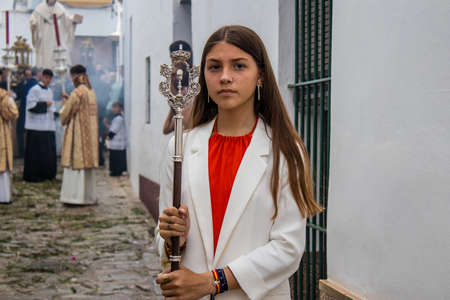 Carmona, Spain - June 19, 2022 Corpus Christi of Carmona, religious procession through the streets to Santa Maria Church, made up of religious statues, young children, christians and a music bandのeditorial素材
