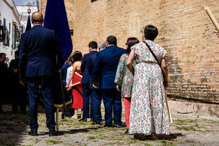 Carmona, Spain - June 19, 2022 Corpus Christi of Carmona, religious procession through the streets to Santa Maria Church, made up of religious statues, young children, christians and a music bandのeditorial素材