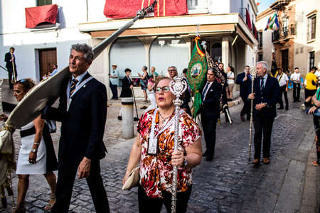 Carmona, Spain - June 18, 2022 Corpus Christi of Carmona, Religious procession in the streets, transfer from San Blas church of the Virgen of the Rosary to Santa Maria church, people pray in the wayのeditorial素材