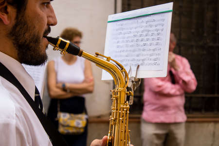 Carmona, Spain - June 19, 2022 Corpus Christi of Carmona, religious procession through the streets to Santa Maria Church, made up of religious statues, young children, christians and a music bandのeditorial素材