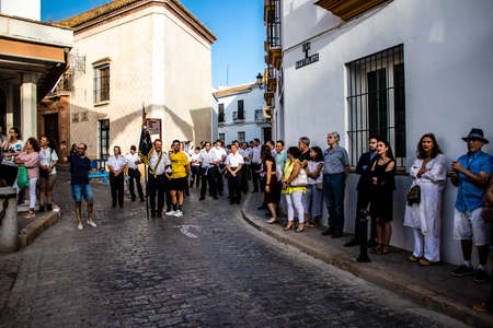 Carmona, Spain - June 18, 2022 Corpus Christi of Carmona, Religious procession in the streets, transfer from San Blas church of the Virgen of the Rosary to Santa Maria church, people pray in the wayのeditorial素材