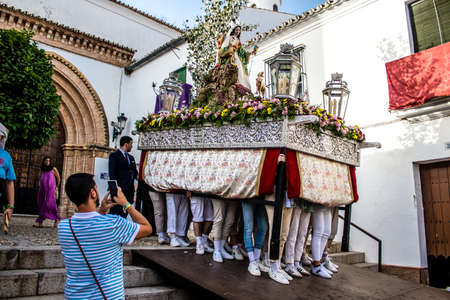 Carmona, Spain - June 18, 2022 Corpus Christi of Carmona, Religious procession in the streets, transfer from San Blas church of the Virgen of the Rosary to Santa Maria church, people pray in the wayのeditorial素材