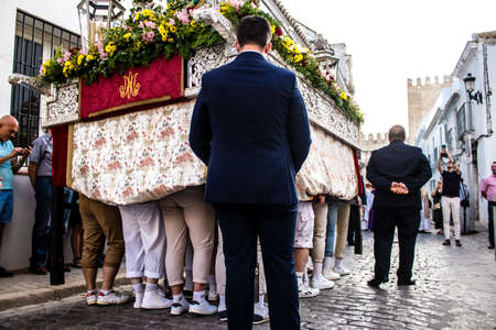 Carmona, Spain - June 18, 2022 Corpus Christi of Carmona, Religious procession in the streets, transfer from San Blas church of the Virgen of the Rosary to Santa Maria church, people pray in the wayのeditorial素材
