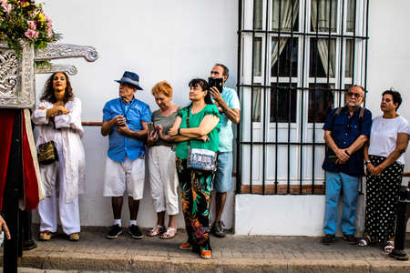 Carmona, Spain - June 18, 2022 Corpus Christi of Carmona, Religious procession in the streets, transfer from San Blas church of the Virgen of the Rosary to Santa Maria church, people pray in the wayのeditorial素材