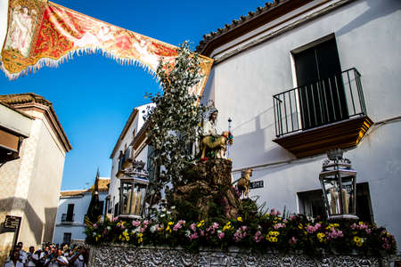 Carmona, Spain - June 18, 2022 Corpus Christi of Carmona, Religious procession in the streets, transfer from San Blas church of the Virgen of the Rosary to Santa Maria church, people pray in the wayのeditorial素材