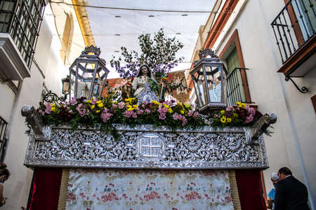 Carmona, Spain - June 18, 2022 Corpus Christi of Carmona, Religious procession in the streets, transfer from San Blas church of the Virgen of the Rosary to Santa Maria church, people pray in the wayのeditorial素材