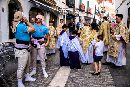 Carmona, Spain - June 18, 2022 Corpus Christi of Carmona, Religious procession in the streets, transfer from San Blas church of the Virgen of the Rosary to Santa Maria church, people pray in the wayのeditorial素材