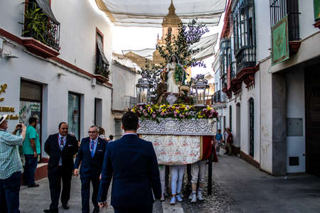 Carmona, Spain - June 18, 2022 Corpus Christi of Carmona, Religious procession in the streets, transfer from San Blas church of the Virgen of the Rosary to Santa Maria church, people pray in the wayのeditorial素材