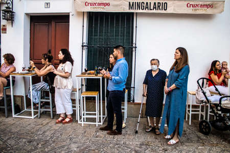 Carmona, Spain - June 18, 2022 Corpus Christi of Carmona, Religious procession in the streets, transfer from San Blas church of the Virgen of the Rosary to Santa Maria church, people pray in the wayのeditorial素材