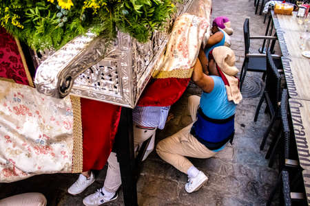 Carmona, Spain - June 18, 2022 Corpus Christi of Carmona, Religious procession in the streets, transfer from San Blas church of the Virgen of the Rosary to Santa Maria church, people pray in the wayのeditorial素材