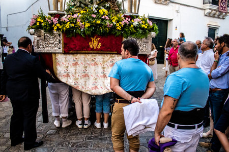 Carmona, Spain - June 18, 2022 Corpus Christi of Carmona, Religious procession in the streets, transfer from San Blas church of the Virgen of the Rosary to Santa Maria church, people pray in the wayのeditorial素材