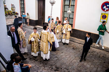 Carmona, Spain - June 18, 2022 Corpus Christi of Carmona, Religious procession in the streets, transfer from San Blas church of the Virgen of the Rosary to Santa Maria church, people pray in the wayのeditorial素材