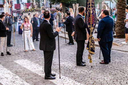 Carmona, Spain - June 18, 2022 Corpus Christi of Carmona, Religious procession in the streets, transfer from San Blas church of the Virgen of the Rosary to Santa Maria church, people pray in the wayのeditorial素材
