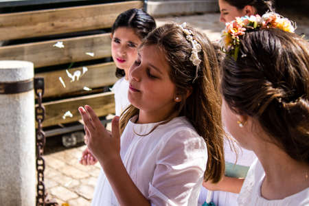 Carmona, Spain - June 19, 2022 Corpus Christi de Carmona, religious procession with young children...
