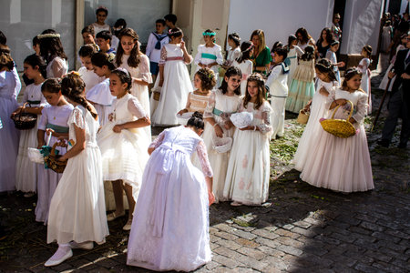 Carmona, Spain - June 19, 2022 Corpus Christi de Carmona, religious procession with young children walking through the streets to Santa Maria Churchのeditorial素材