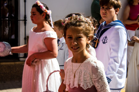 Carmona, Spain - June 19, 2022 Corpus Christi de Carmona, religious procession with young children...