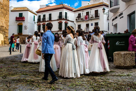 Carmona, Spain - June 19, 2022 Corpus Christi of Carmona, religious procession with young children walking through the streets to Santa Maria Churchのeditorial素材