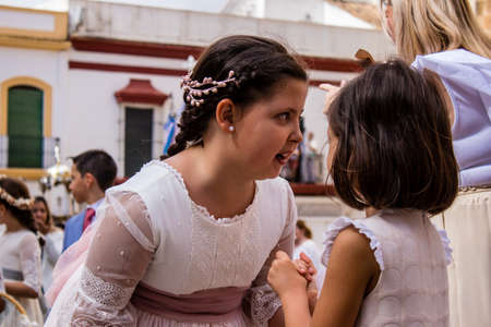 Carmona, Spain - June 19, 2022 Corpus Christi of Carmona, religious procession with young children walking through the streets to Santa Maria Churchのeditorial素材