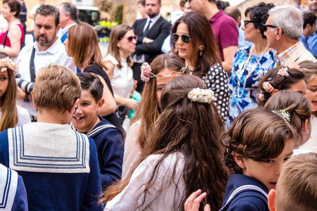Carmona, Spain - June 19, 2022 Corpus Christi of Carmona, religious procession with young children walking through the streets to Santa Maria Churchのeditorial素材