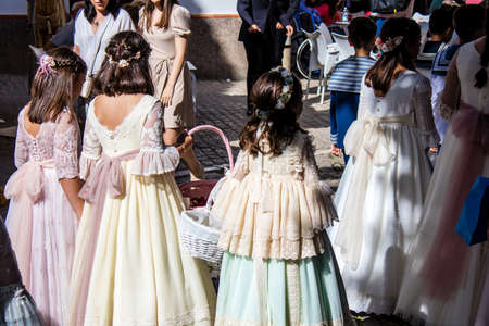 Carmona, Spain - June 19, 2022 Corpus Christi de Carmona, religious procession with young children through the streets to Santa Maria Churchのeditorial素材