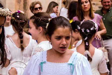 Carmona, Spain - June 19, 2022 Corpus Christi of Carmona, religious procession with young children walking through the streets to Santa Maria Churchのeditorial素材