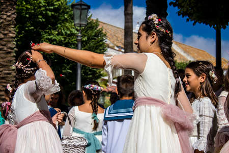 Carmona, Spain - June 19, 2022 Corpus Christi de Carmona, religious procession with young children...