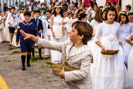 Carmona, Spain - June 19, 2022 Corpus Christi de Carmona, religious procession with young children through the streets to Santa Maria Churchのeditorial素材