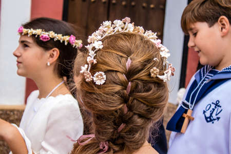 Carmona, Spain - June 19, 2022 Corpus Christi de Carmona, religious procession with young children through the streets to Santa Maria Churchのeditorial素材