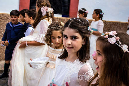Carmona, Spain - June 19, 2022 Corpus Christi de Carmona, religious procession with young children walking through the streets to Santa Maria Churchのeditorial素材