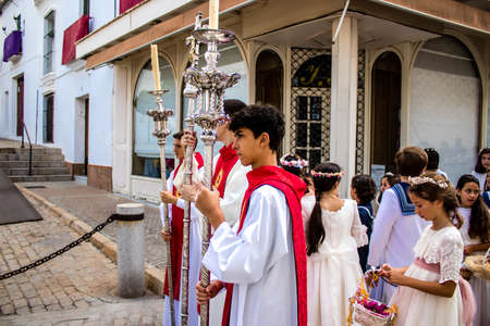Carmona, Spain - June 19, 2022 Corpus Christi de Carmona, religious procession with young children walking through the streets to Santa Maria Churchのeditorial素材