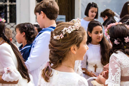 Carmona, Spain - June 19, 2022 Corpus Christi de Carmona, religious procession with young children walking through the streets to Santa Maria Churchのeditorial素材