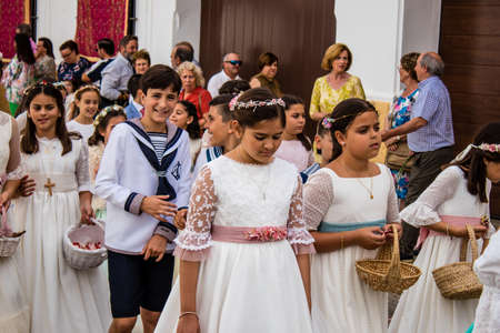 Carmona, Spain - June 19, 2022 Corpus Christi de Carmona, religious procession with young children through the streets to Santa Maria Churchのeditorial素材