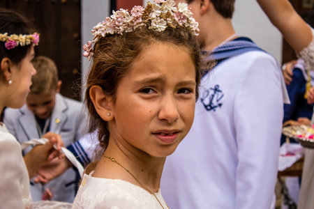 Carmona, Spain - June 19, 2022 Corpus Christi de Carmona, religious procession with young children through the streets to Santa Maria Churchのeditorial素材