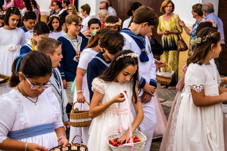 Carmona, Spain - June 19, 2022 Corpus Christi de Carmona, religious procession with young children...