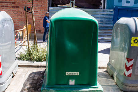 Seville, Spain - July 04, 2022 Garbage container in the streets of Seville, an emblematic city and...