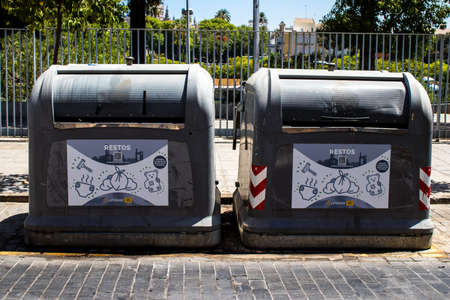 Seville, Spain - July 04, 2022 Garbage container in the streets of Seville, an emblematic city and the capital of the region of Andalusia, in the south of Spainのeditorial素材