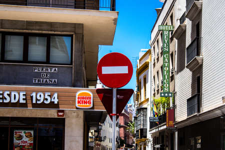 Seville, Spain - July 04, 2022 Street sign or road sign, erected at the side of or above roads to provide information to road user in the downtown area of Sevilleのeditorial素材
