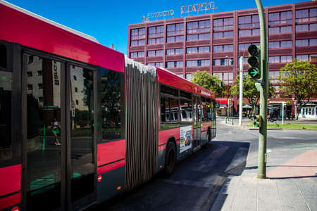 Seville, Spain - July 04, 2022 Bus driving through the streets of Seville during the coronavirus outbreak hitting Spain, wearing a mask is mandatoryのeditorial素材