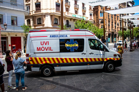 Seville, Spain - July 04, 2022 Ambulance driving through the streets of Seville during the coronavirus outbreak hitting Spain, wearing a mask is mandatoryのeditorial素材