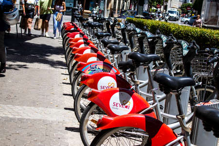 Seville, Spain - July 04, 2022 Accessible bicycles to hire for short periods of time, usually for a few hours parked in the streets and part of the public transport system of Sevilleのeditorial素材
